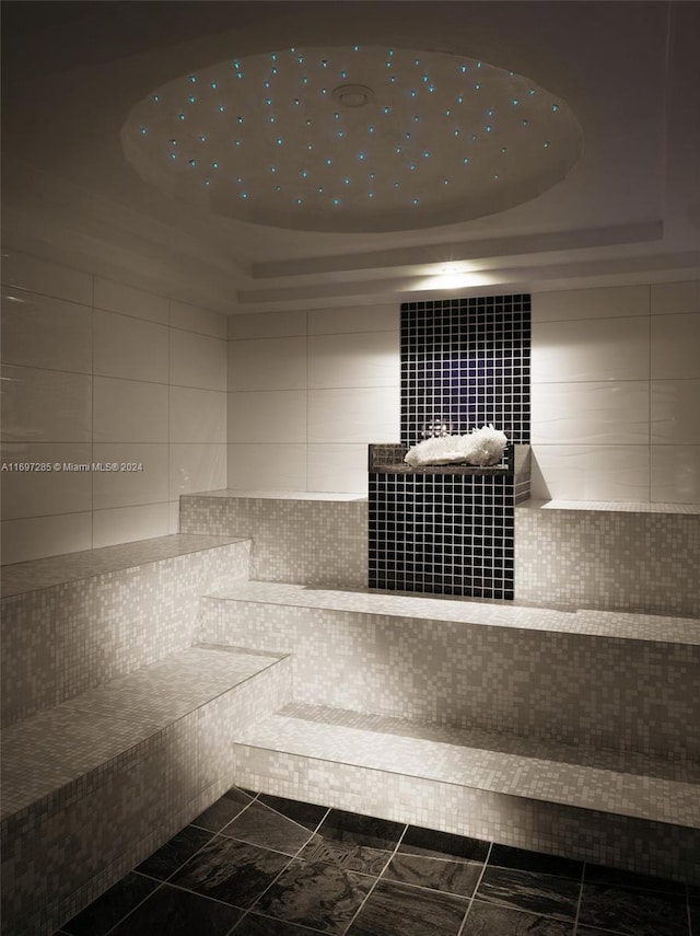 bathroom with tile patterned floors and tile walls