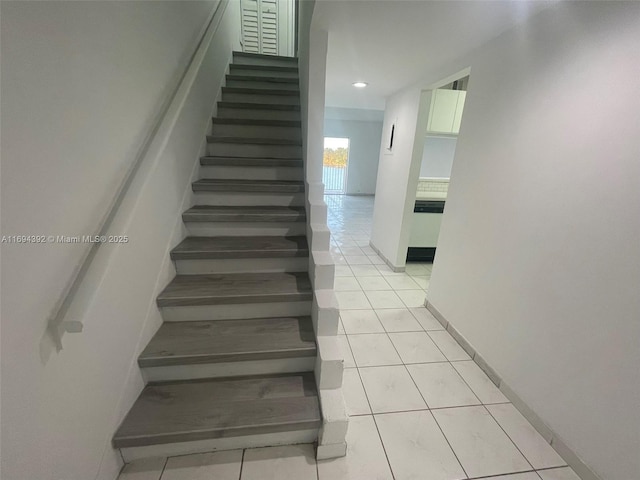 stairs featuring tile patterned floors