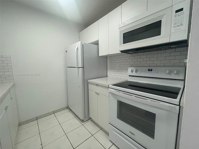 kitchen featuring white cabinets, decorative backsplash, white appliances, and light tile patterned floors