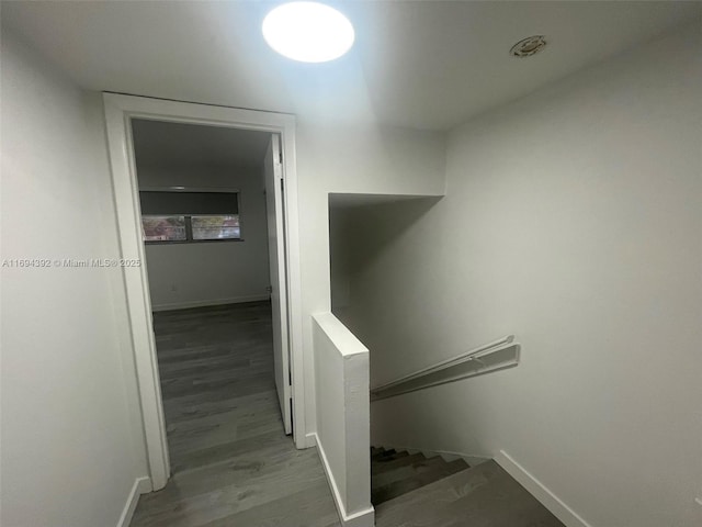 corridor with hardwood / wood-style flooring