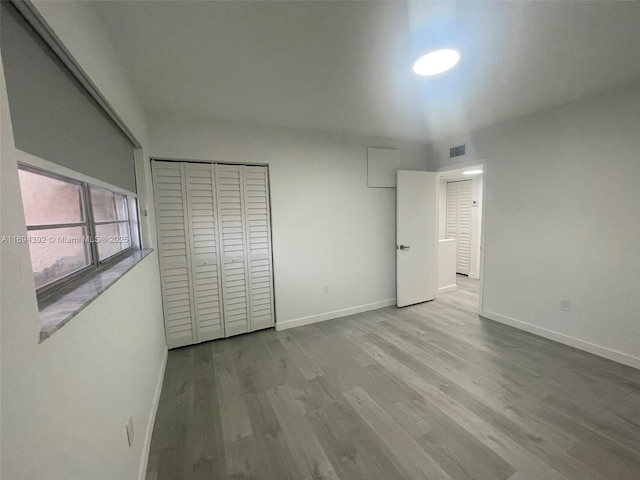 unfurnished bedroom featuring a closet and light hardwood / wood-style floors