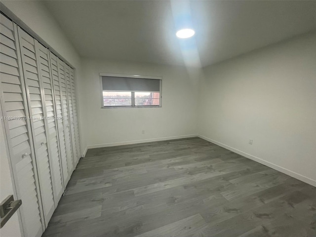 unfurnished bedroom with a closet and wood-type flooring