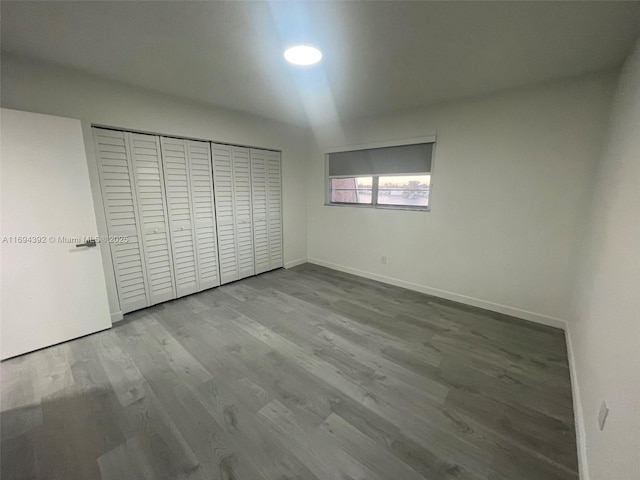 unfurnished bedroom featuring light wood-type flooring and a closet