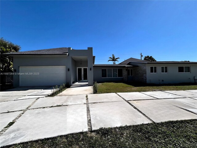 view of front of house with a garage and a front yard