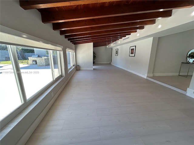 interior space featuring beam ceiling and light hardwood / wood-style floors