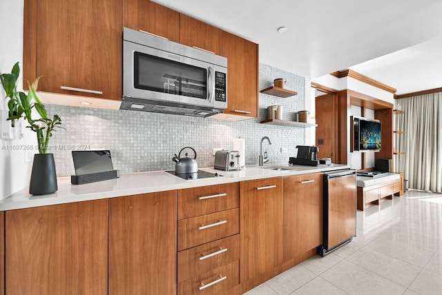 kitchen featuring sink, tasteful backsplash, dishwashing machine, black electric stovetop, and light tile patterned floors