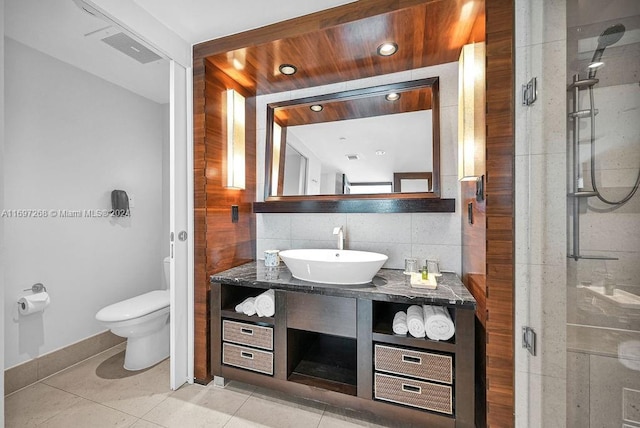 bathroom featuring walk in shower, tile patterned floors, backsplash, toilet, and vanity