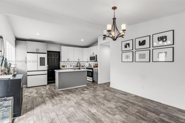 kitchen featuring pendant lighting, wood-type flooring, an island with sink, white cabinetry, and stainless steel appliances