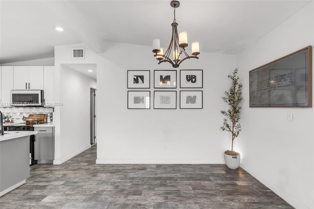 dining room with dark hardwood / wood-style flooring, lofted ceiling with beams, and a notable chandelier