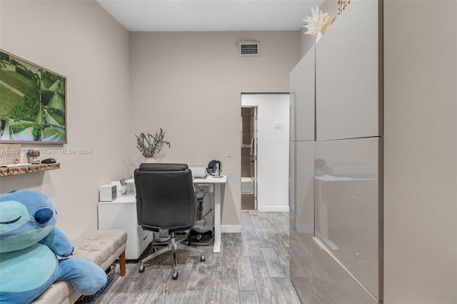 office with light wood-type flooring