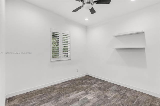 spare room featuring dark hardwood / wood-style flooring and ceiling fan