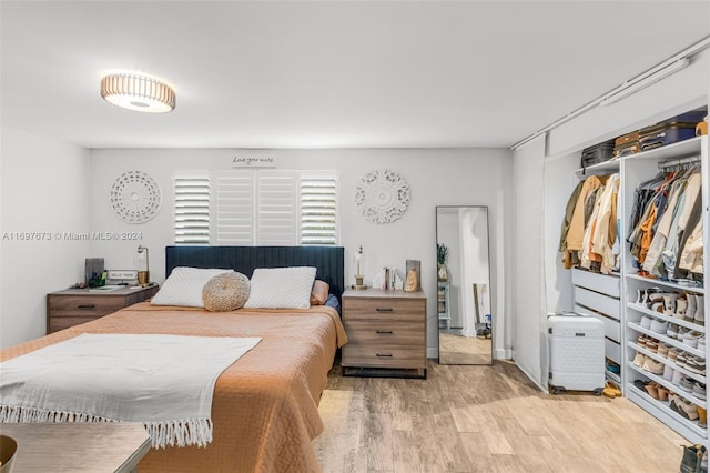 bedroom featuring light hardwood / wood-style flooring and a closet