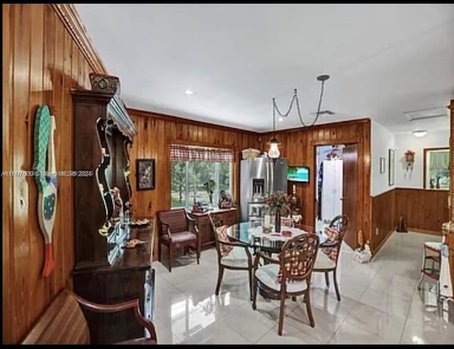 dining space featuring wooden walls