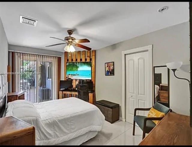 bedroom featuring light tile patterned floors, a closet, and ceiling fan