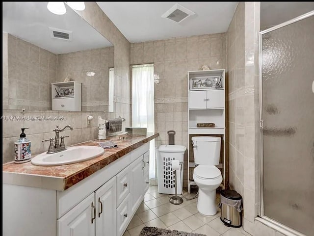 bathroom featuring tile patterned floors, vanity, and tile walls