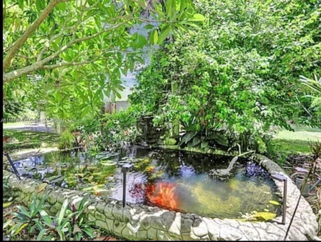 exterior space featuring a garden pond