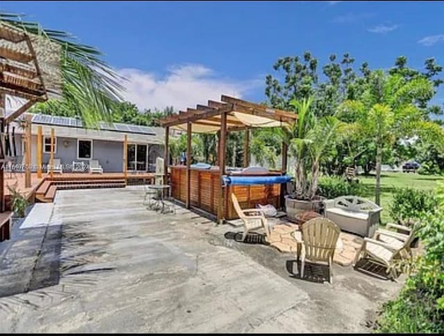 view of patio / terrace featuring a pergola, a hot tub, and a deck