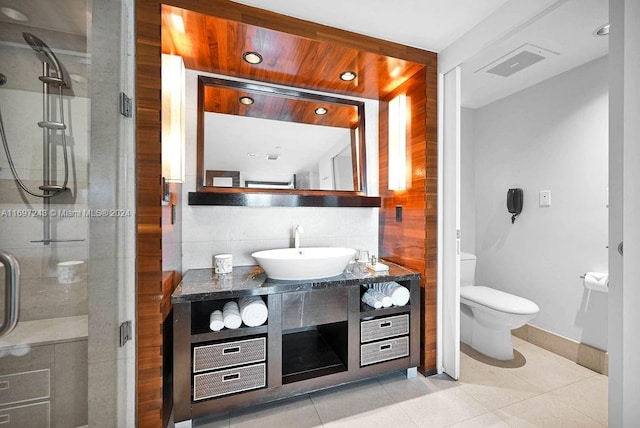 bathroom with decorative backsplash, vanity, tile patterned flooring, toilet, and a shower with shower door