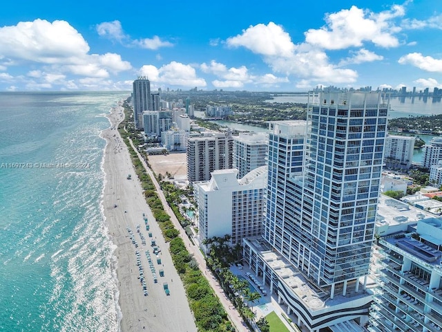 drone / aerial view with a water view and a beach view