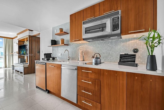 kitchen with tasteful backsplash, sink, light tile patterned floors, and appliances with stainless steel finishes