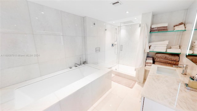 1200 W Ave Unit 931, Miami Beach, FL 33139 - bathroom featuring vanity, a shower stall, and a garden tub
