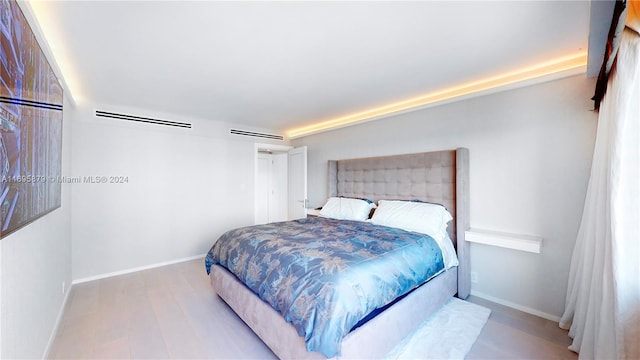 bedroom with light hardwood / wood-style floors