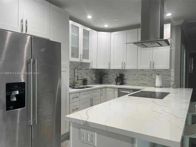 kitchen featuring island exhaust hood, stainless steel fridge with ice dispenser, white cabinets, and light stone counters