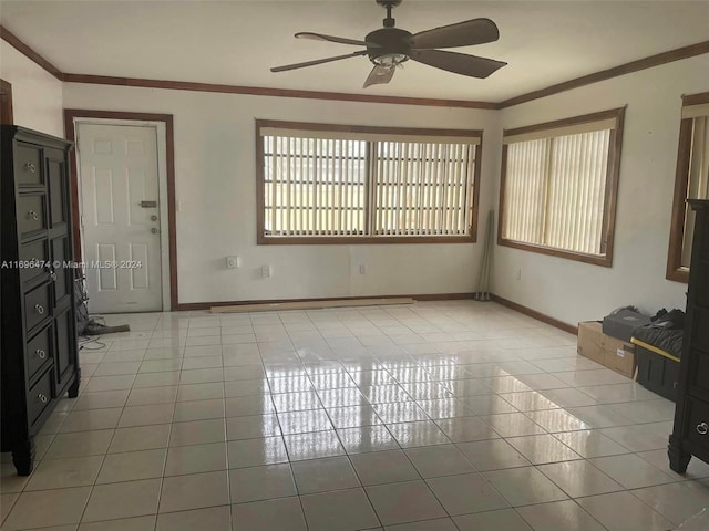 unfurnished living room featuring ceiling fan, crown molding, and light tile patterned floors