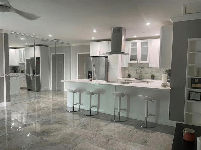 kitchen with white cabinets, stainless steel refrigerator with ice dispenser, and wall chimney exhaust hood