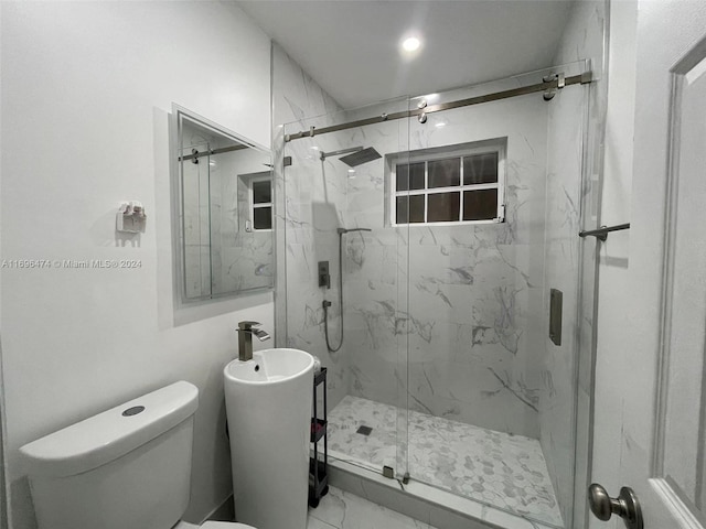 bathroom with toilet and a shower with door