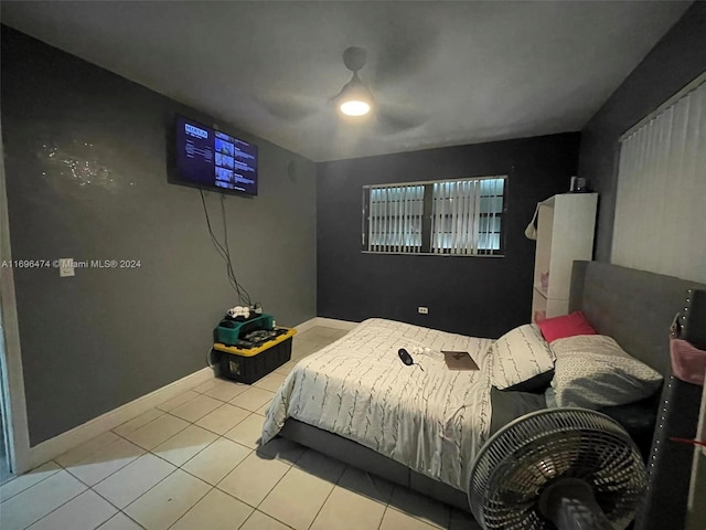 bedroom with ceiling fan and light tile patterned floors