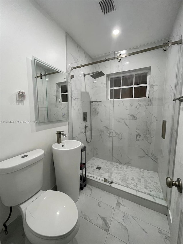 bathroom with toilet and an enclosed shower