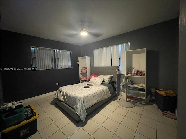 bedroom with ceiling fan and light tile patterned flooring