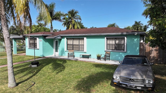 rear view of property featuring a yard