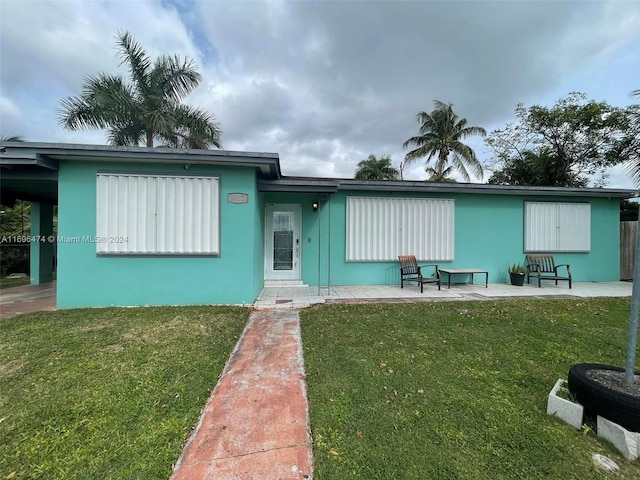 view of front of home with a patio area and a front lawn