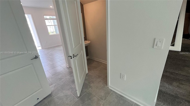 hall featuring light tile patterned floors