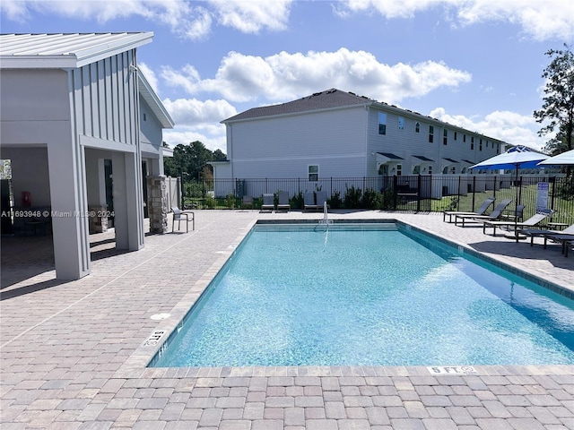 view of swimming pool with a patio area