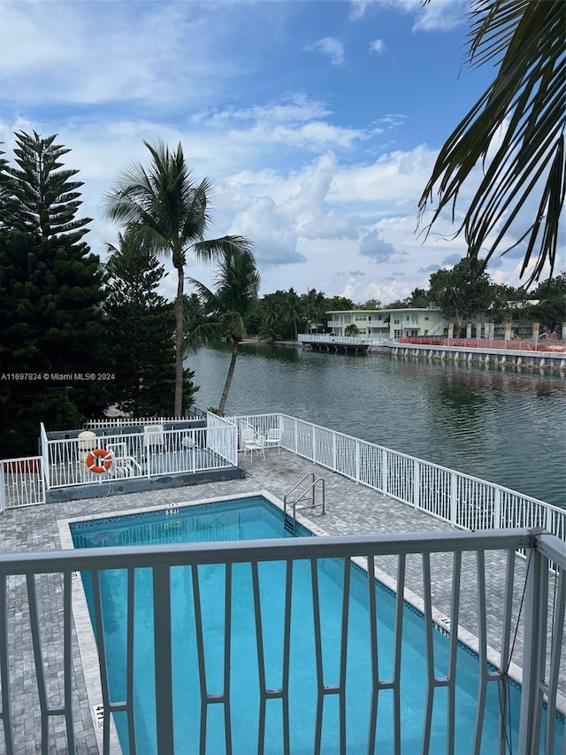 view of pool with a water view