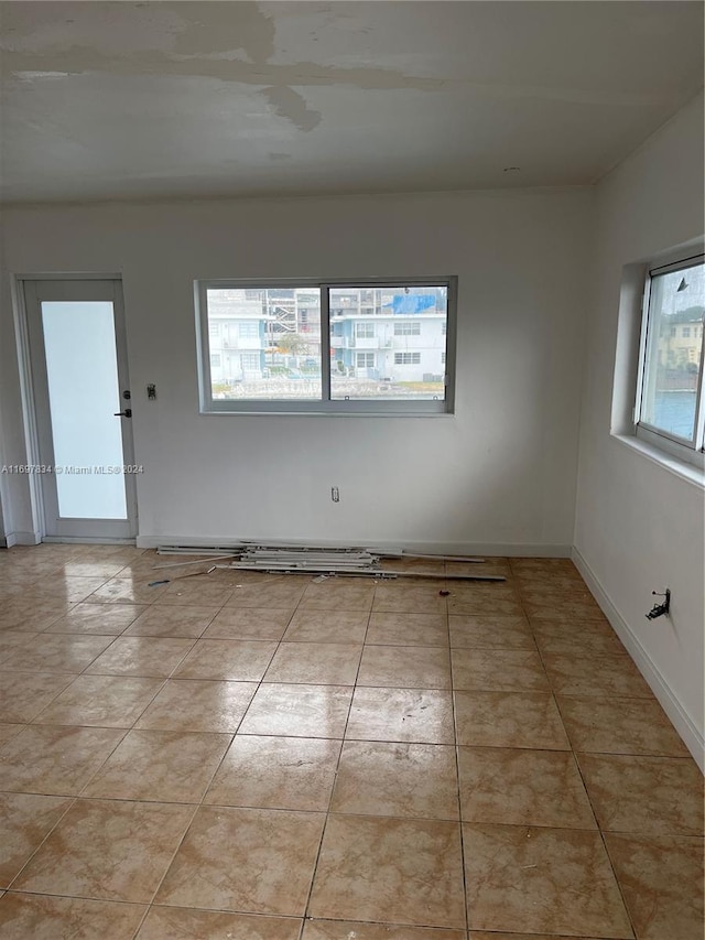 tiled spare room with a wealth of natural light