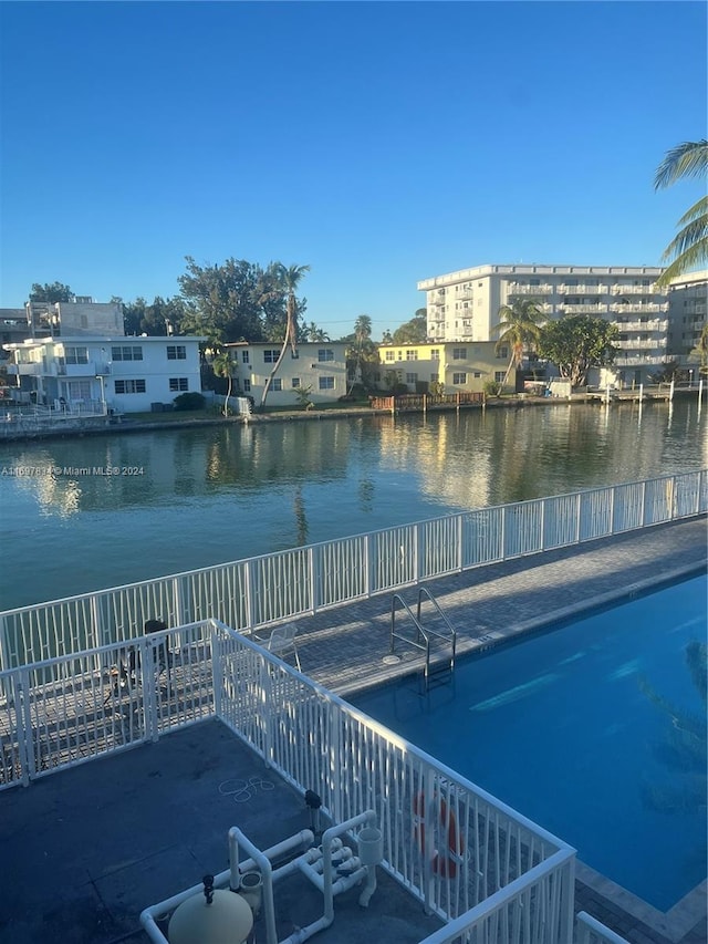 view of dock featuring a water view and a community pool