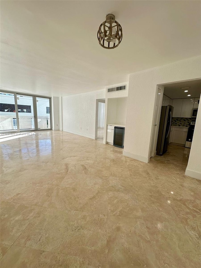 unfurnished living room with a wall of windows