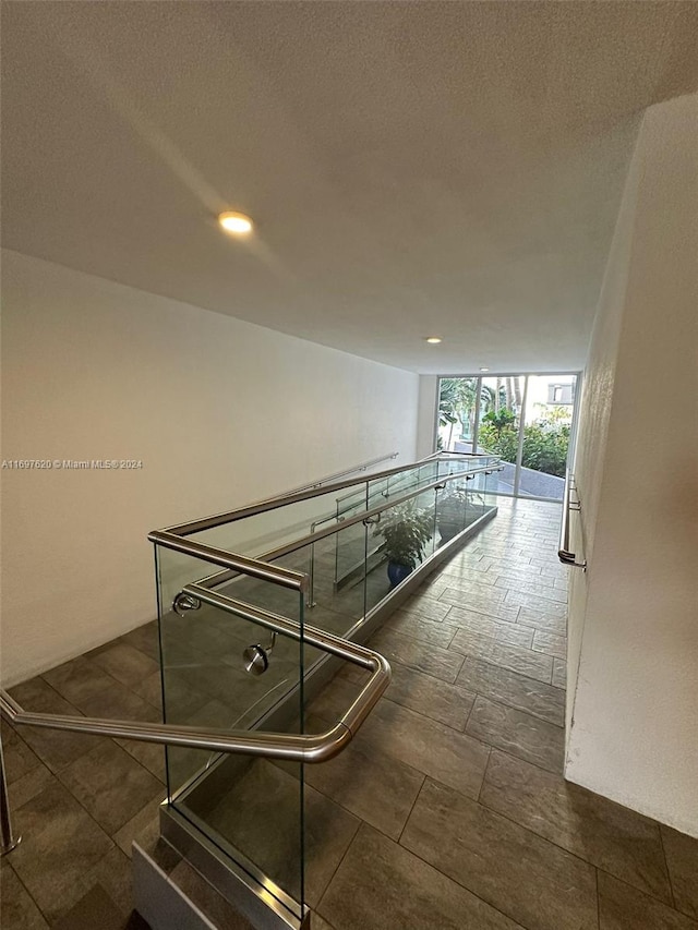 hallway with a textured ceiling