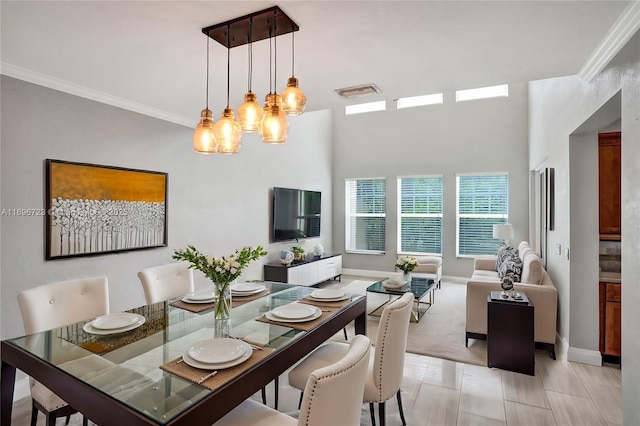 dining space featuring crown molding and a notable chandelier