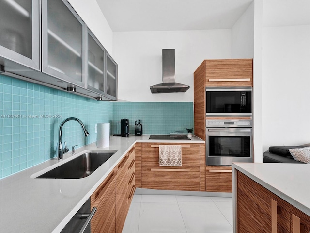 kitchen featuring appliances with stainless steel finishes, backsplash, wall chimney exhaust hood, and sink