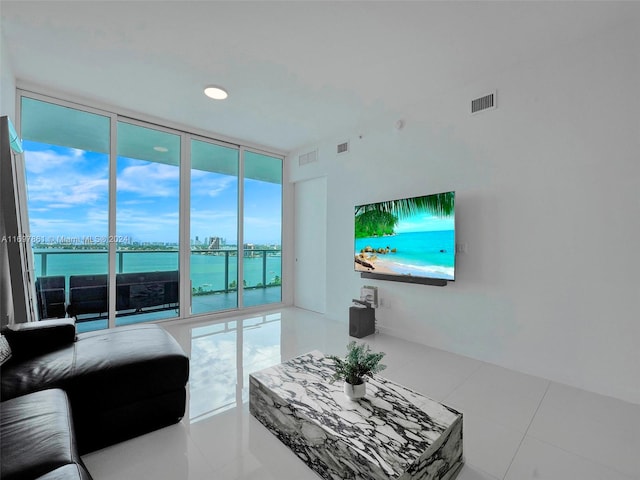 living room with tile patterned floors and a wall of windows