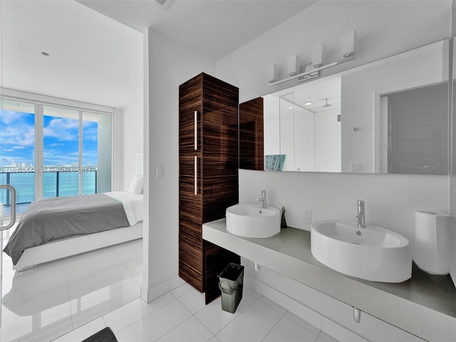 bathroom with tile patterned floors, sink, and a water view