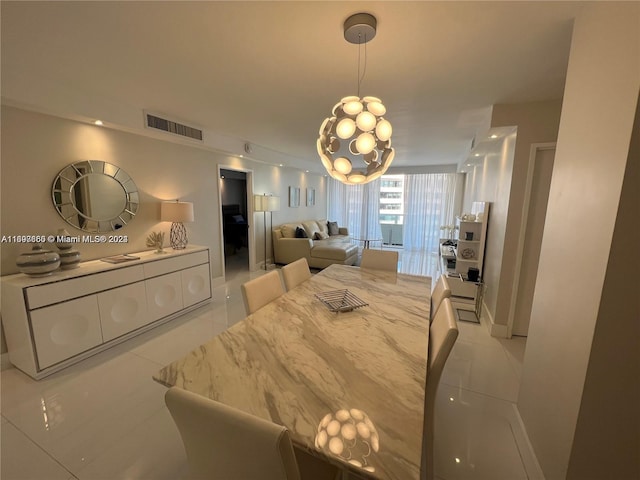 tiled dining area featuring an inviting chandelier