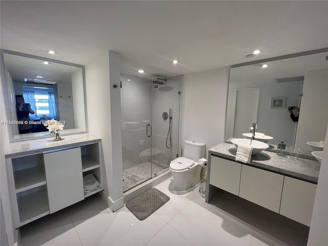 bathroom with toilet, vanity, tile patterned floors, and an enclosed shower