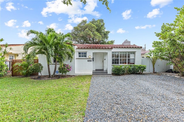 mediterranean / spanish-style home with a front yard