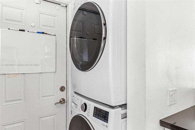 laundry area featuring stacked washer / dryer